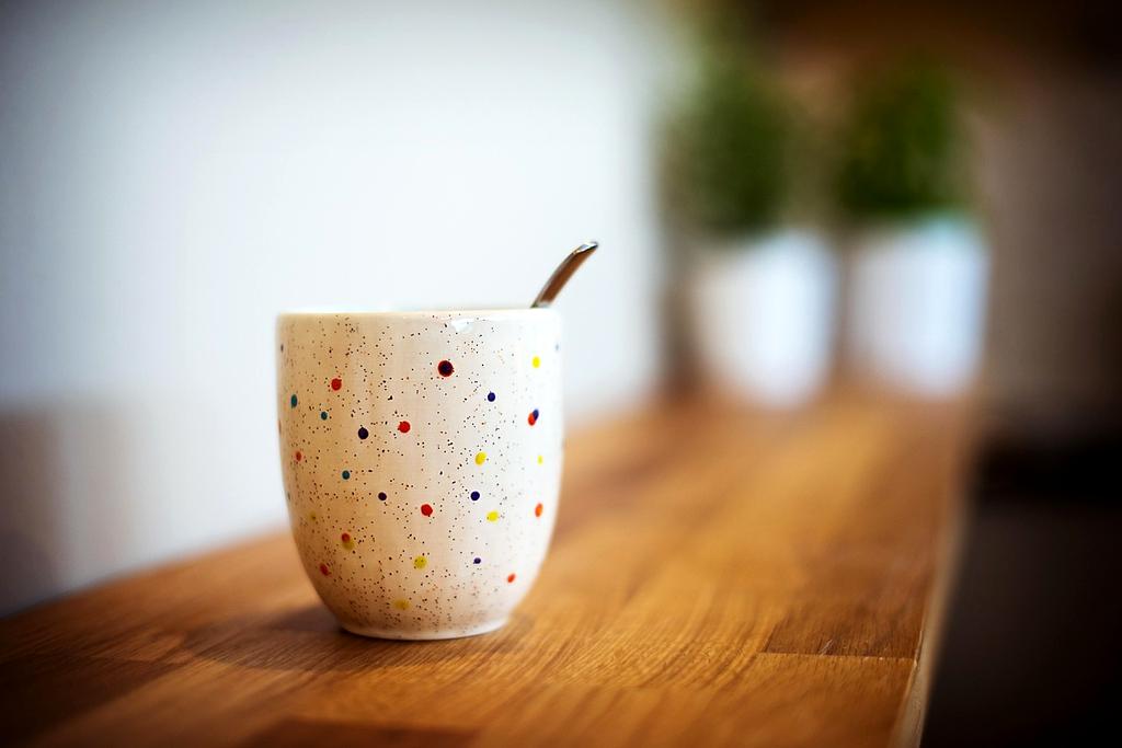 Professional espresso extraction with golden crema flowing into ceramic cup