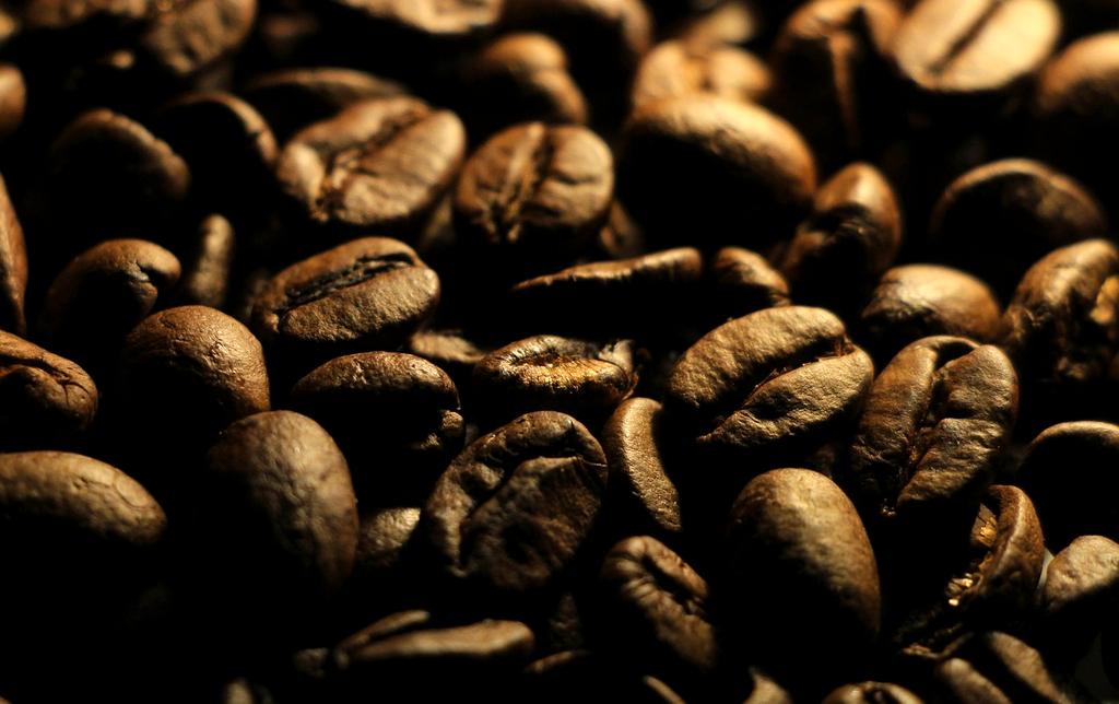 Pour-over coffee brewing with kettle and filter cone on wooden table